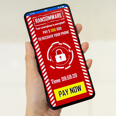 hand holding an iphone that has ransomware on it