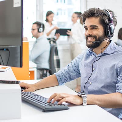 IT consultant smiling at desk