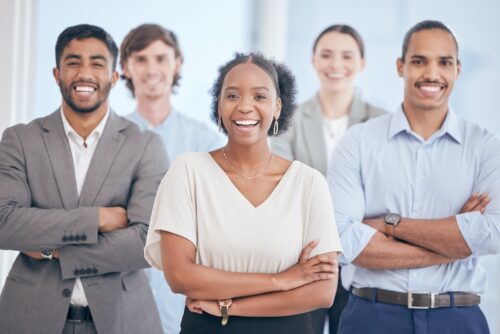 happy employees looking at camera while in office