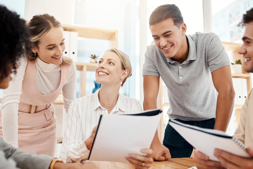 happy employees in a work meeting discussing company culture